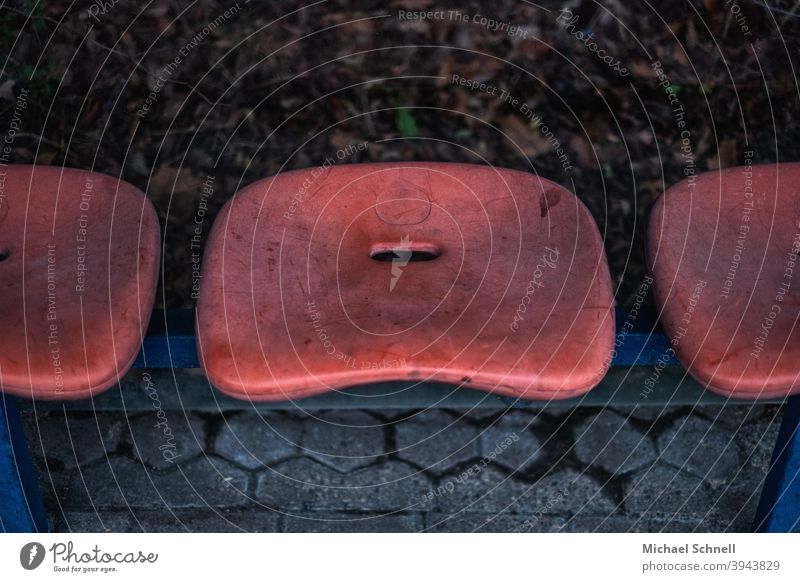 Bucket seats at a bus stop Seat Sit Wait Shelter Bus stop Stop (public transport) Orange seat shell filthy Scratched inhospitable