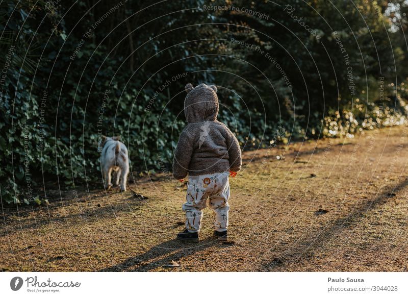 Toddler looking at dog at the park toddlerhood Dog Pet Together Animal portrait Nature Human being Colour photo pet Cute 1 Exterior shot Authentic Happy Puppy