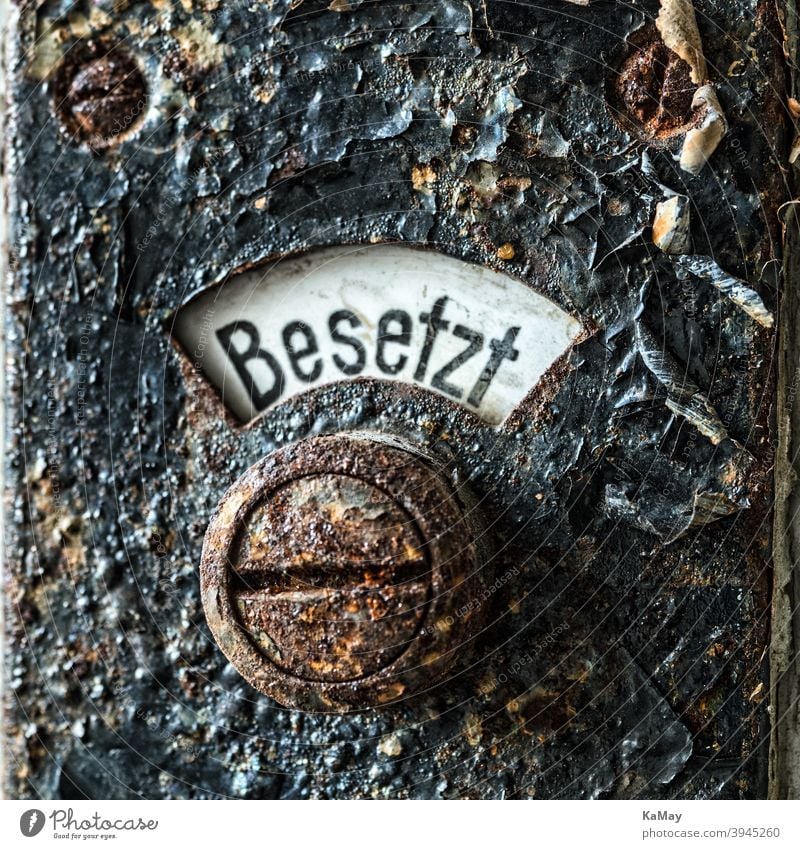 Close-up of an old rusty lavatory sign historical occupied close-up macro detail toilet restroom grunge black metal iron abstract option digestion WC concept