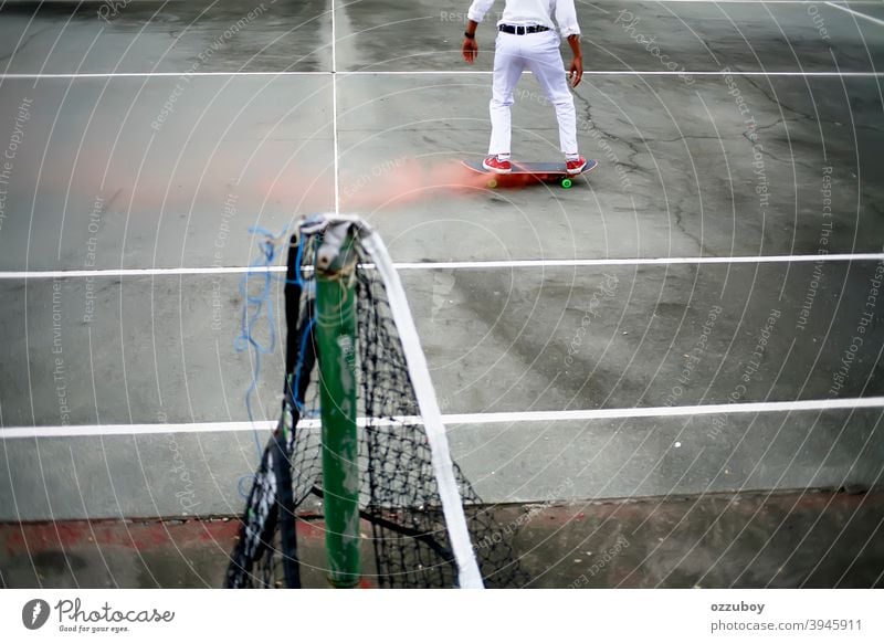 skateboarder playing in tennis court with pink smoke on skateboard leisure life balance subculture background copy space one person real people equipment deck