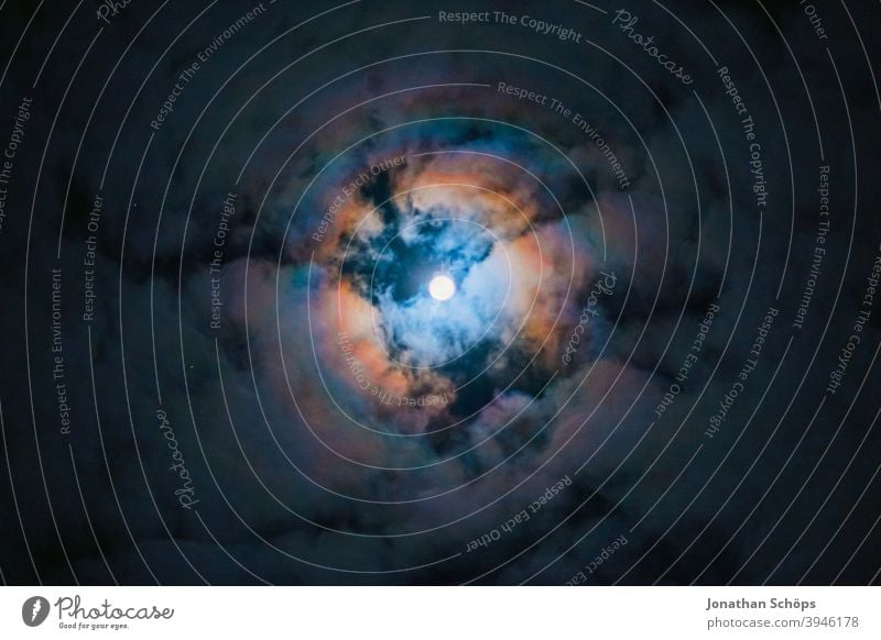 Full moon behind clouds Aura December wreath of light Moon Rauhnacht Full  moon Clouds Dark somber Night at night Sky Light Long exposure Night sky