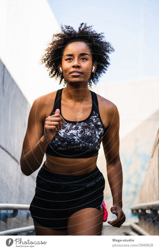 Afro athlete woman running outdoors. sport exercise training runner background people care leisure body portrait sports action motion cardio exercising