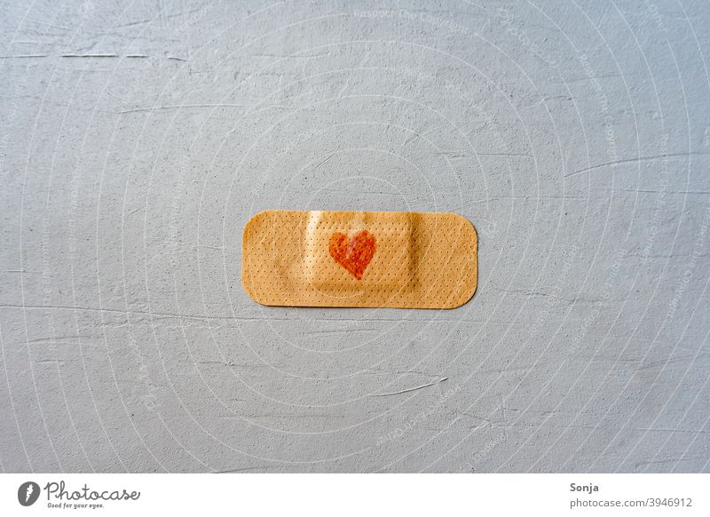 A plaster with heart on a gray background pavement Heart-shaped Red Immunization Healthy Virus Illness Hospital vaccine med Medical treatment coronavirus