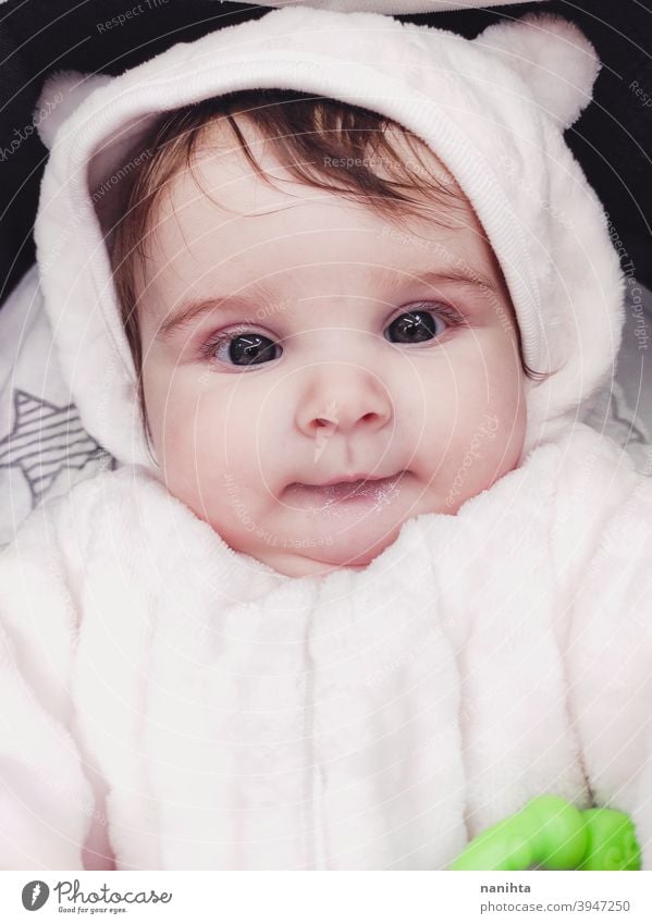 Lovely portrait of a baby girl wearing winter clothes infancy cute little face eyes gray eyes newborn parenthood child cutie lovely adorable cozy pose