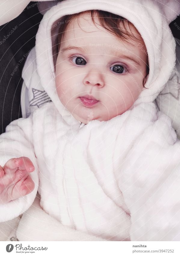 Lovely portrait of a baby girl wearing winter clothes infancy cute little face eyes gray eyes newborn parenthood child cutie lovely adorable cozy pose