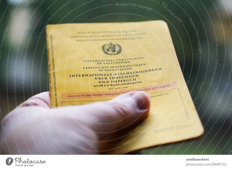 Hand holding International Certificates of Vaccination and Vaccination Booklet Vaccination book Vaccination certificate Immunization Healthy Illness medicine