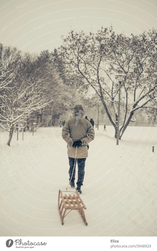 A man pulls a sled through the snow. Winter atmosphere. Sleigh Pull Landscape wood sledges winter landscape Snow Winter mood Snowscape Cold out Nature trees Man