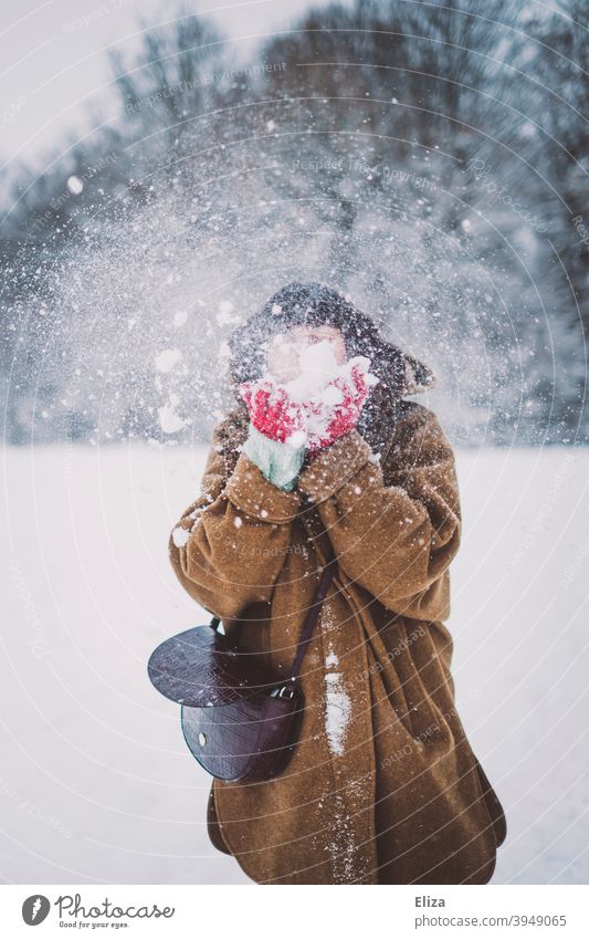 A woman with a cloud of snow in front of her face Snow snow cloud blow winter Winter Woman youthful snow flurries Snowscape Nature Winter mood Winter's day Cold