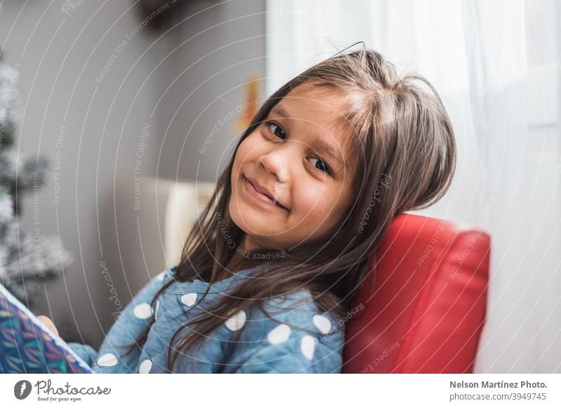 Shallow focus shot of a happy little girl with dark hair. Portrait Hispanic Child Girl childhood portrait kid cute beautiful Infancy young happiness smile