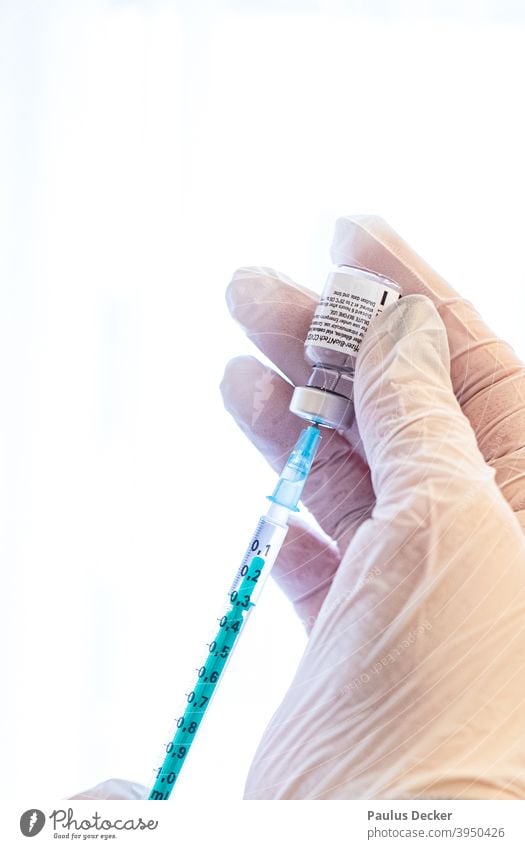 Physician's assistant draws up vaccine dose with Corona vaccine during a vaccination campaign in a retirement home corona covid-19 Immunization Biontec pandemic