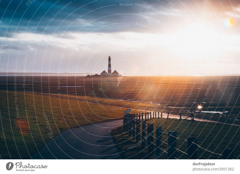 Sunset at the lighthouse Westerheversand on the peninsula Eiderstedt II Wide angle Panorama (View) Long shot Worm's-eye view Deep depth of field Sunlight