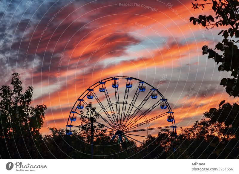 Ferris wheel at sunset in Tineretului Park, Bucharest pleasure Attraction Carnival Carousel Circle City Clouds dramatic sky Entertainment Evening Fair