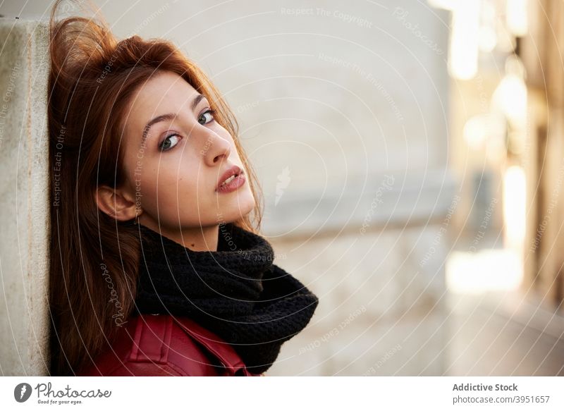 Confident young female millennial leaning on old building wall woman chill street self assured city relax alone confident trendy cool charismatic leather jacket