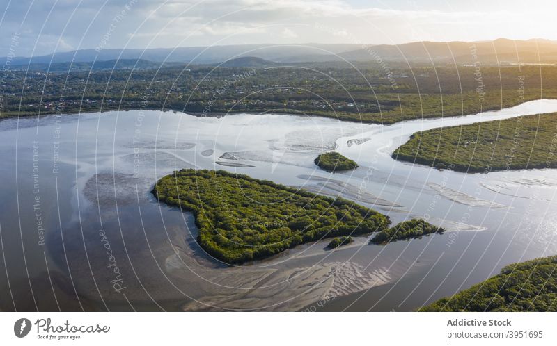 Scenic green island in river under sunset sky heart landscape countryside nature picturesque coast scenic forest tree vegetate australia lush water riverside