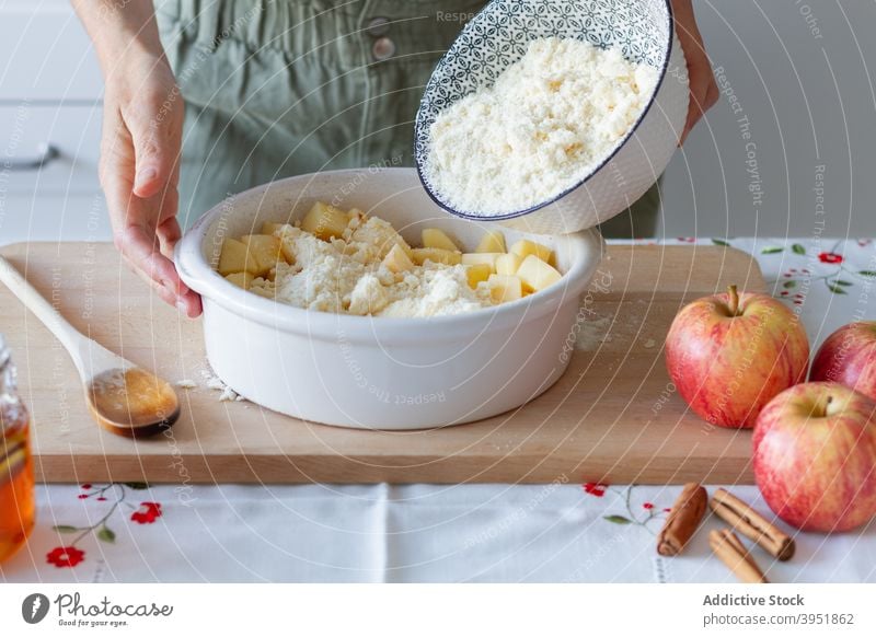 Crop person preparing apple crumble cook kitchen home add dough ingredient cut pan honey cinnamon homemade fresh table recipe prepare food organic meal healthy