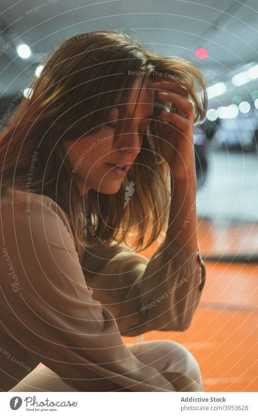 Thoughtful young woman relaxing with closed eyes in contemporary building rest eyes closed touch hair pensive thoughtful dreamy tranquil modern contemplate