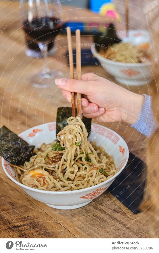 Woman eating traditional oriental ramen asian food noodle delicious bowl chopstick dish female pork egg meal tasty meat yummy woman cuisine lunch palatable