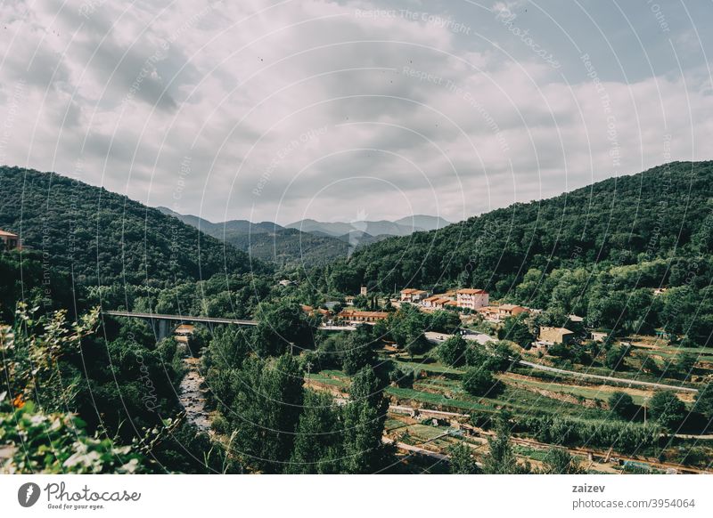 mountains of sadernes on a cloudy summer day in spain girona spain catalonia green nature wood beauty blue bright foliage road rock scenery scenic sky sunlight