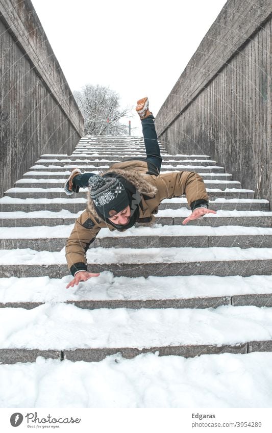 Man slip on ice and falling down stairs Slippery surface Slip and fall Slip on ice Falling down stairs Stairs Winter Ice Snow Risky Injury Dangerous Accident