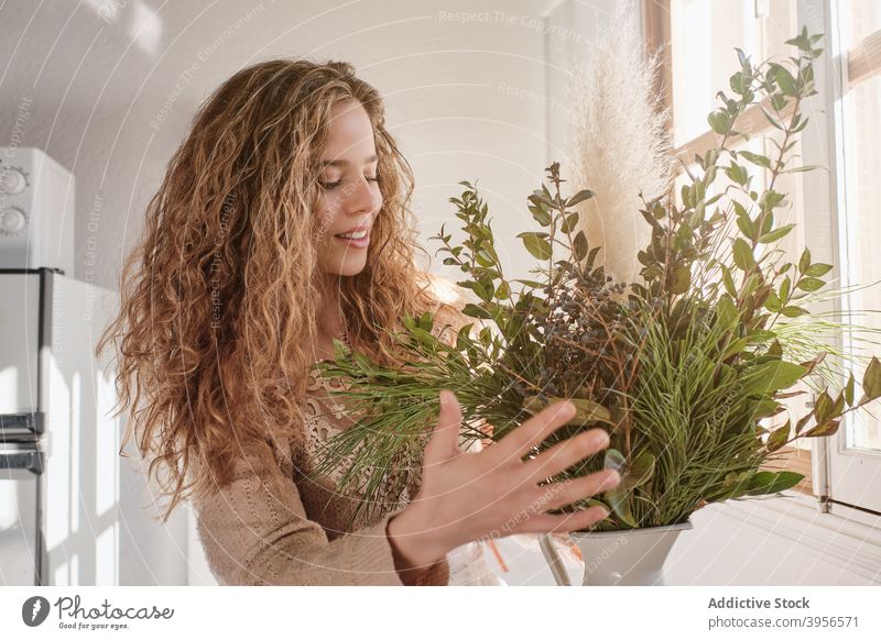 Woman arranging plants in vase bunch woman bouquet fresh gentle flora floristry home female table green style natural harmony decor organic romantic tender