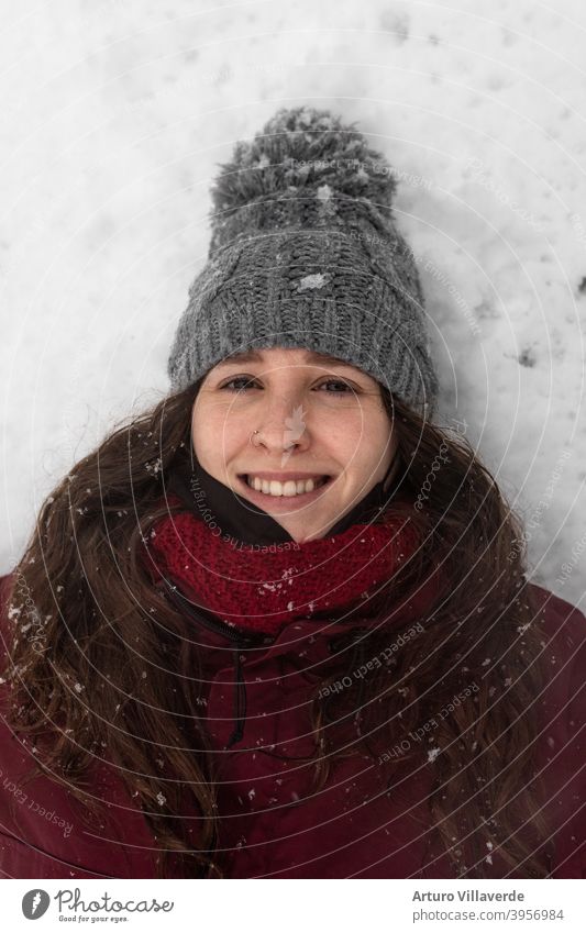 portrait young woman in the snow, wears a gray cap and a red coat. He's smiling looking up at the sky pretty Close-up Markets Hooded (clothing) Fashion Happy