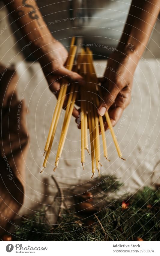 Woman with candles decorating home for Christmas christmas decoration prepare hand table xmas celebrate holiday festive female event new year tradition december