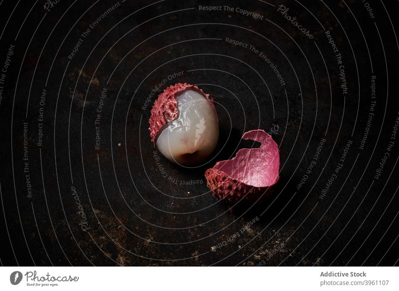 Top view of lychee on dark rustic wooden background fruit fresh whole pile exotic tropical unpeeled asian chinese china closeup delicious food group ingredient