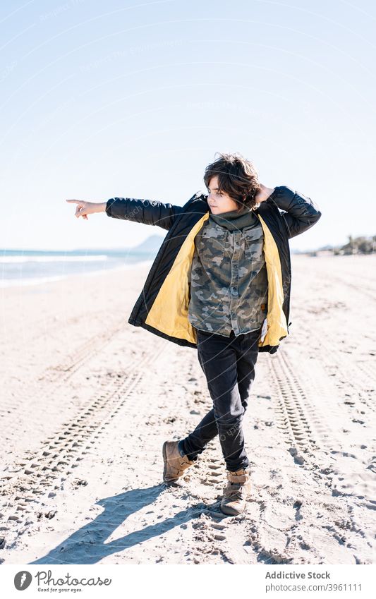 Portrait of boy walking on the beach in winter child mediterranean sea mediterranean culture authentic active break children coast cold concept enjoy family fun