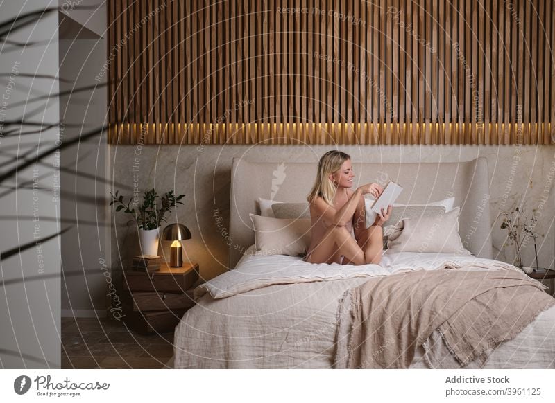 Woman reading book on bed in evening woman enjoy story sleepwear bedroom home female sit interesting novel comfort fiction cozy weekend relax pajama chill lady