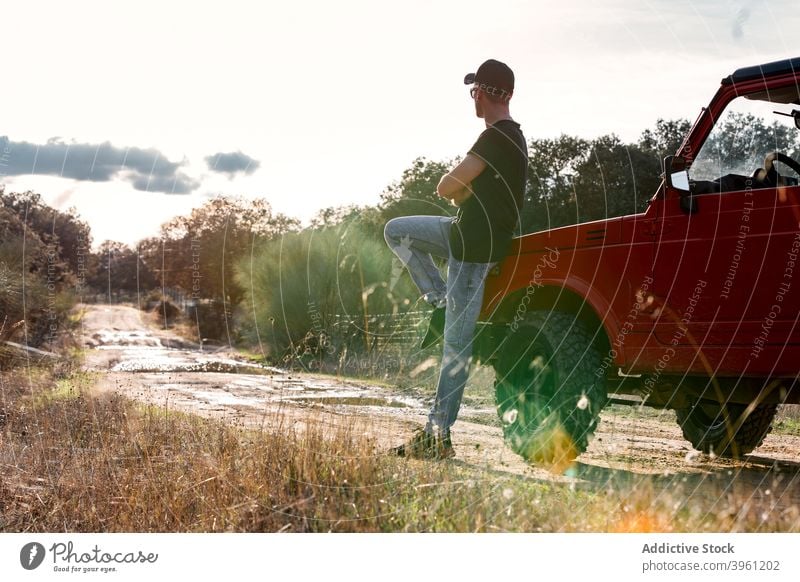 Man standing near SUV car in summer countryside man off road suv adventure nature thoughtful journey travel vehicle lifestyle contemplate male forest trip