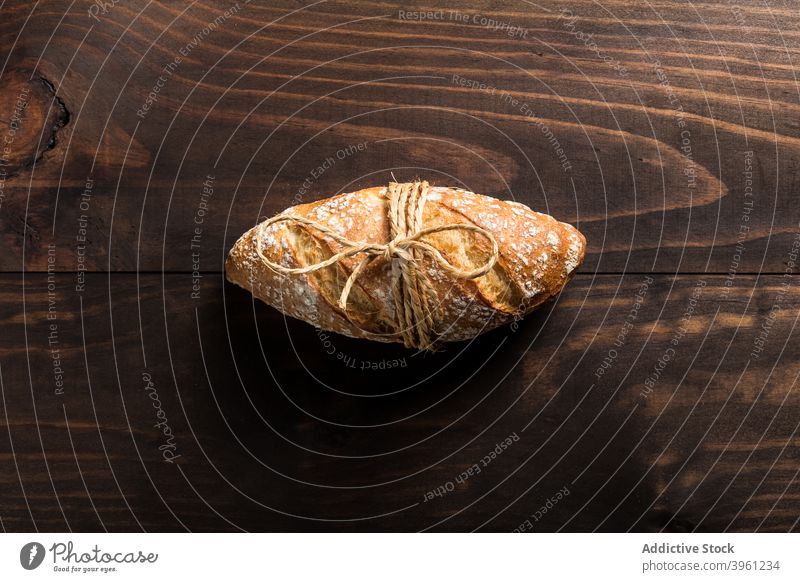 Loaf of fresh baked bread loaf crispy food bakery whole artisan crust delicious wooden table nutrition tradition meal cuisine crunch golden natural cook organic