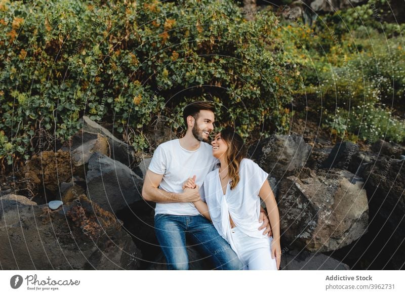 Happy couple enjoying summer holidays on rocky coast romantic love embrace happy fondness together nature young tenerife island canary spain relationship