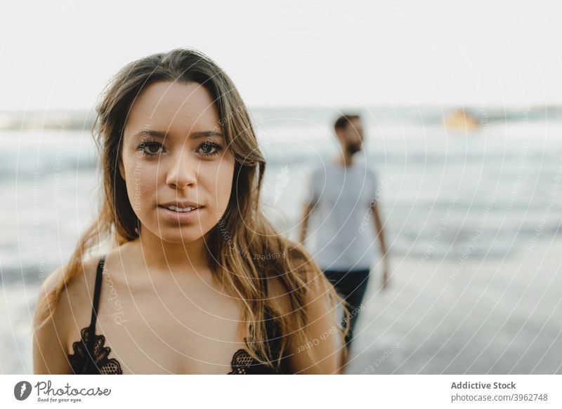 Young woman enjoying summer holidays on beach with boyfriend sea happy couple young ocean relationship shore romantic girlfriend female island tenerife spain