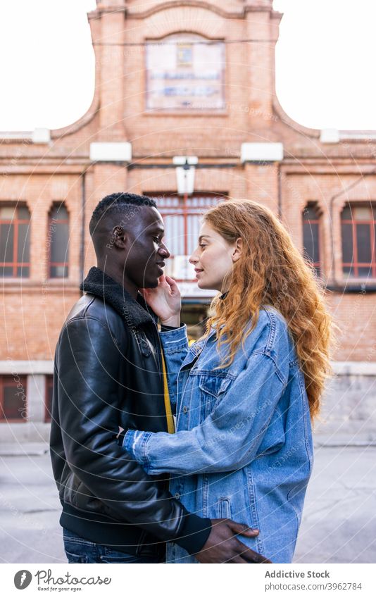 Multiracial couple cuddling on street cuddle together tender city style trendy delicate love relationship multiethnic multiracial diverse black african american