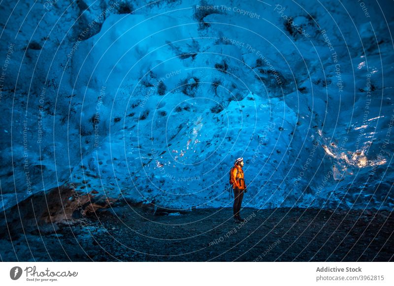 Traveler standing in ice cave in winter traveler adventure explorer light cold frozen nature iceland tourism blue landscape rock arctic scenic vacation polar