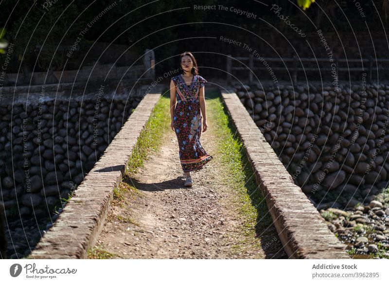 Woman standing on bridge in forest woman summer vacation carefree relax brick aged heritage female daping red bridge taiwan travel trip tourist enjoy style