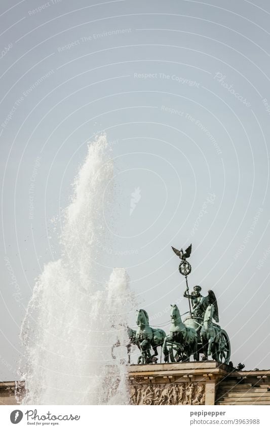 Brandenburg Gate with water fountain in the foreground Berlin Architecture Capital city Quadriga Landmark Tourist Attraction Exterior shot Manmade structures