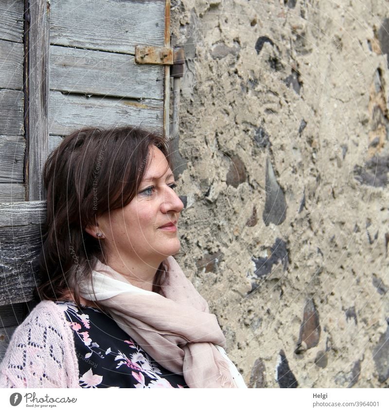 Portrait in half profile of a brunette long-haired woman in front of a historical house facade Human being Woman Lady portrait Half-profile Long-haired Smiling