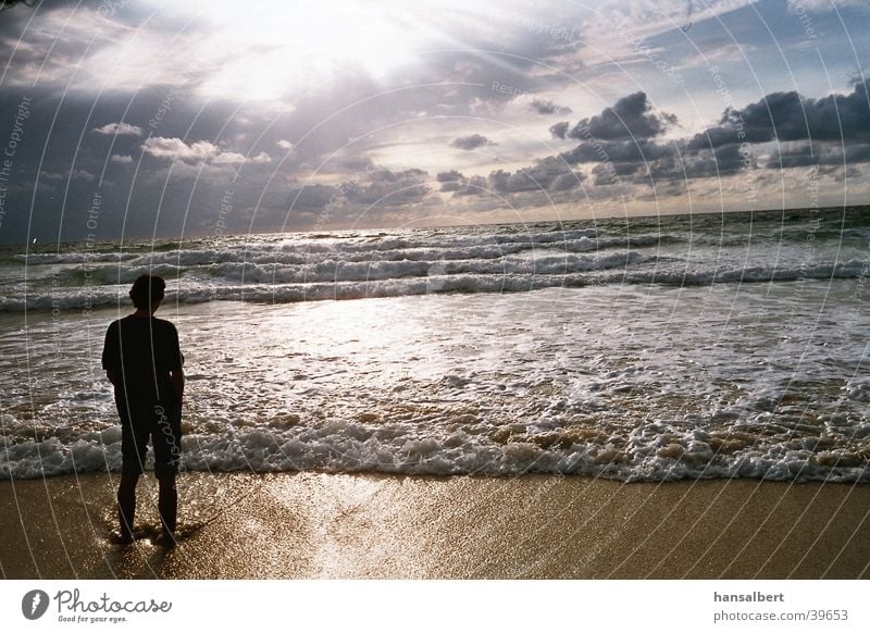 silhouette by the sea Ocean Visual spectacle Surf Atlantic Ocean Clouds Play of colours Silhouette Sun