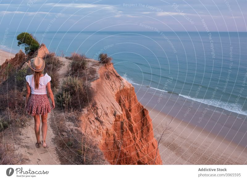 Anonymous woman standing in mountain cliff in Tavira coastline nature summer sea portugal ocean tavira landscape travel beach mediterranean lifestyle sports