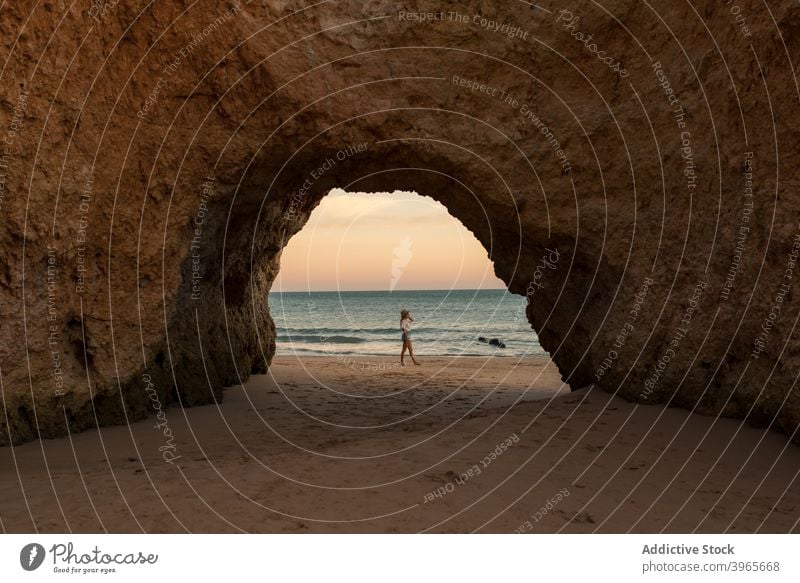 Anonymous woman in cave near sea shore sunset nature sand entrance romantic benagil caves vacation algarve portugal female ocean travel beach coast relax hat