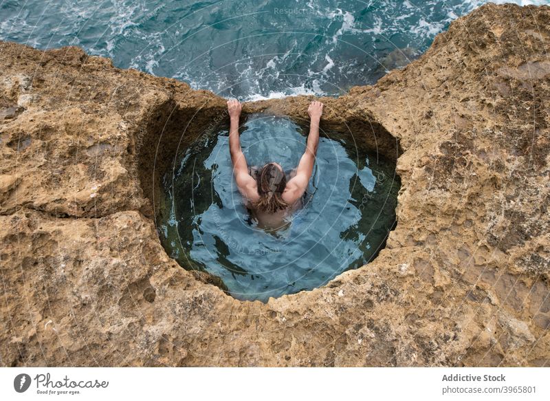 Woman at Algar seco natural caves pool in Algarve, Portugal woman sea admire vacation sunny travel algarve portugal swimming ocean idyllic rock stone tourism