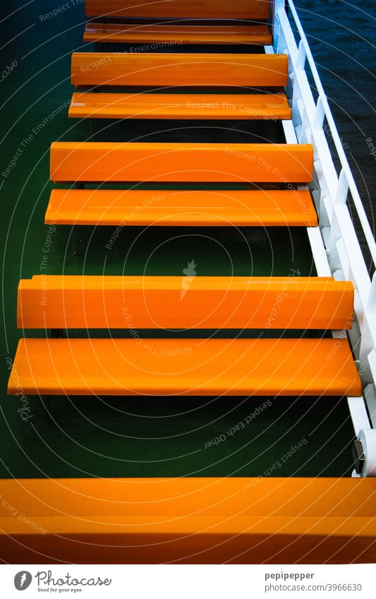 orange benches in a row on a ferryboat Navigation ship Deck Orange Vacation & Travel Tourism Watercraft Trip Ferry Blanket Cruise Passenger ship On board