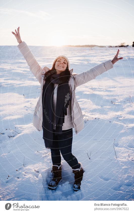 happy young woman hiking in snowy mountain wearing modern coat at sunset. winter season. nature cold caucasian forest wanderlust travel walk hiker tour tourism