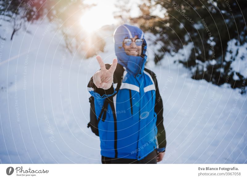 happy handsome man in snowy mountain at sunset. Travel and sport outdoors concept. Winter season hiking winter cold covered caucasian forest wanderlust travel