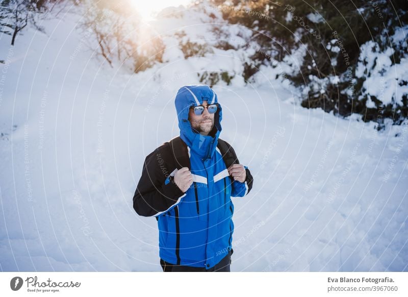 happy handsome man in snowy mountain at sunset. Travel and sport outdoors concept. Winter season hiking winter cold covered caucasian forest wanderlust travel