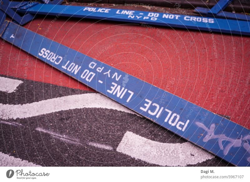 two blue barrier signs with the inscription "Police-Line - Do not Cross - NYPD" are lying on the ground Police Line do not cross nypd Stop sign New York