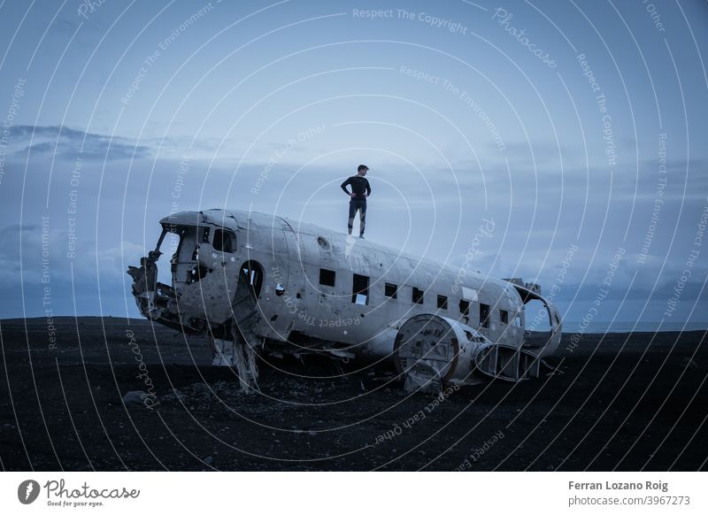 Portrait of a man in Iceland with an abandoned plane iceland crashed Sea sand Old