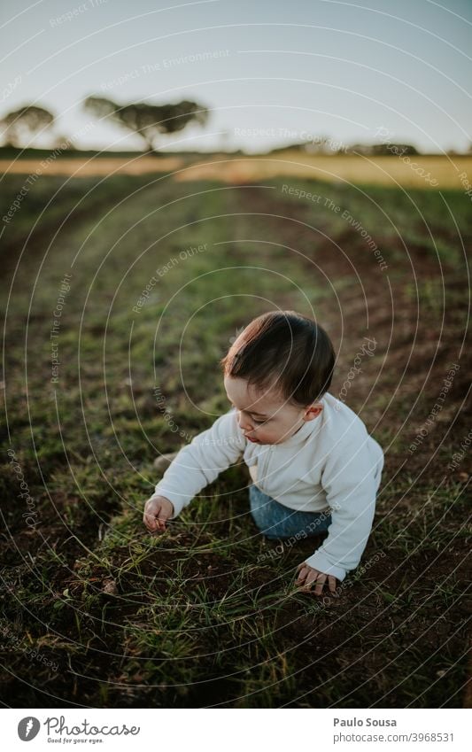 Toddler playing outdoors Authentic Nature Field Autumn Winter Day Calm explore Caucasian Child childhood Family & Relations Joy Playing 1 - 3 years Happiness