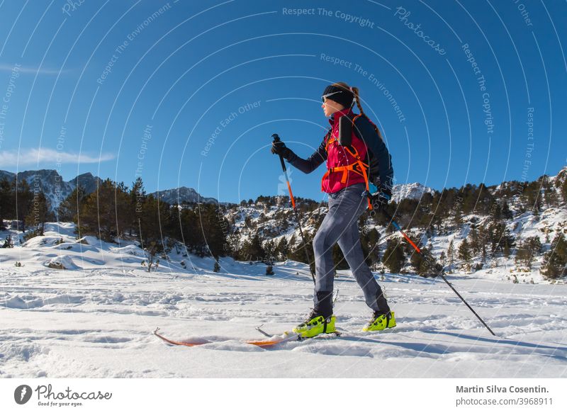 Woman in the mountains practicing mountain skiing in the Pyrenees of Andorra in 2021. active adrenaline adventure alpinist championship climb climber climbing